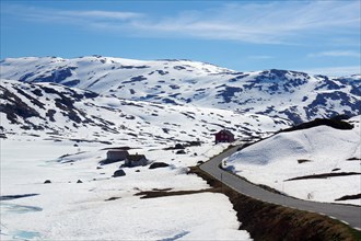 Road winds through wintry landscape in the Fjell