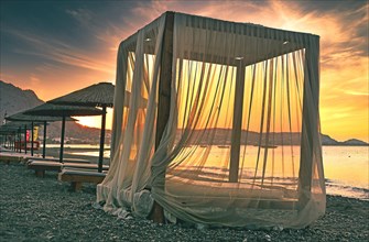 Canopy for beach loungers with curtains and parasols