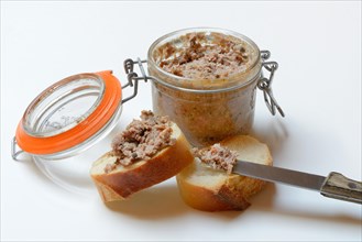 A jar of meat terrine and slices of bread