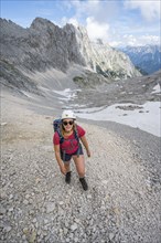 Hiker crossing a scree field