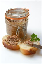 A jar of meat terrine and slices of bread