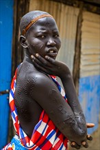 Girl with body scars from the Laarim tribe