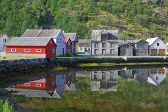 Old wooden houses reflected in the still water
