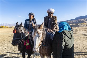 Old men on their horses at a Buzkashi game