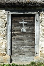 Wooden cross on a door of farm