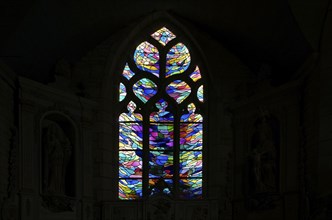 Stained glass window in the chancel of La Chapelle de Notre Dame de Bonne Nouvelle et sa fontaine