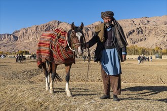 Old man with his horse at a Buzkashi game