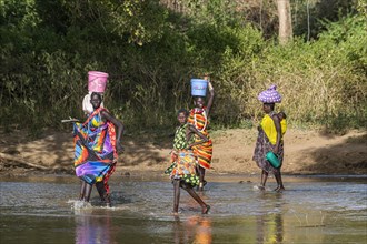 Women walking through a river bed