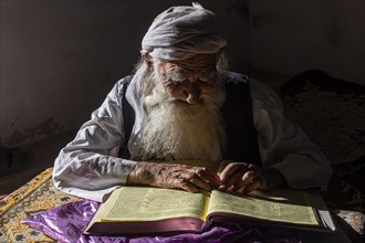 Sufi priest studying the holy Quran in the Shrine of Mawlana Abdur Rahman Jami