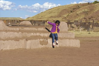 Little indigenous girl jumping from a platform