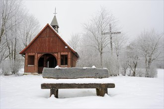Bench in front of Brother Klaus Chapel of Peace in winter