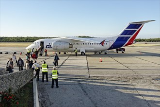 Passengers disembark Antonov An-158 regional jet
