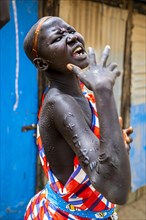 Girl with body scars from the Laarim tribe