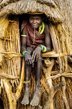 Scar face as a mark of beauty woman sitting in her hut
