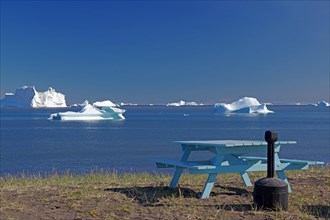 Bench and bay covered with icebergs