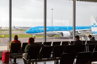Passengers with KLM Royal Dutch Airlines aircraft at Amsterdam Schiphol Airport