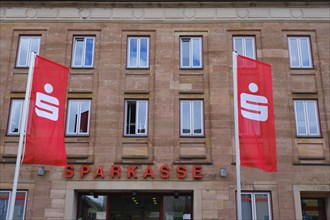 Flags in front of the facade of the savings bank
