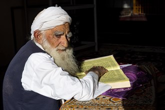 Sufi priest studying the holy Quran in the Shrine of Mawlana Abdur Rahman Jami