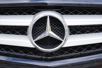 Mercedes star on the radiator grille of the vehicle