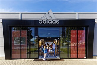 Customers enter Adidas Brand Store