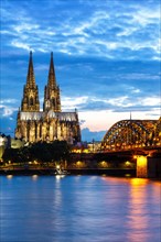 Cologne Cathedral Skyline and Hohenzollern Bridge with Rhine River in Germany at night in Cologne