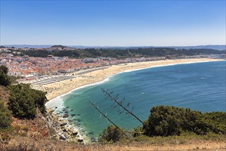 View from the cliffs to the village of Nazare and the beach Praia da Nazare