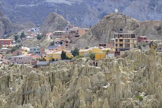Residential houses behind the bizarre rock formations in Valle de la Luna