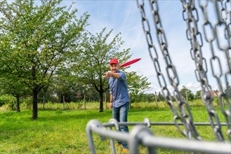 Man throwing a disc at Discgolf