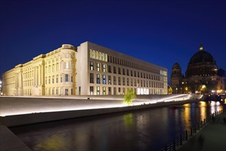 The Berlin Palace or Humboldt Forum along the Spree river and the Berliner Dom illuminated at night