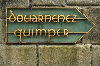 Old road sign shows way to Douarnenez and Qimper