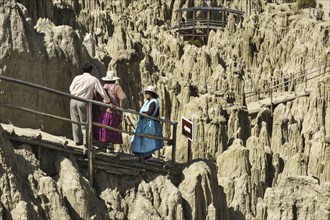 Local tourists in traditional dress admire the bizarre rock formations in the Valle de la Luna