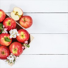 Apples Fruits red apple fruit with blossoms and leaves on wooden board from above with text space Copyspace square