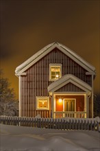 Swedish wooden house in winter at night