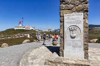 Tourists at the monument with information board