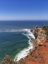 View along the cliffs to the Farol de Nazare lighthouse and the Atlantic Ocean
