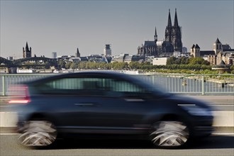 Car in motion on the Zoobruecke with the cathedral in the background