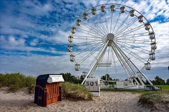 Ferris wheel and beach chair on the beach of Hooksiel