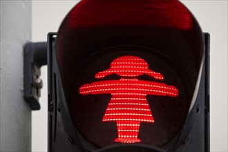 Pedestrian traffic light with red traffic light woman