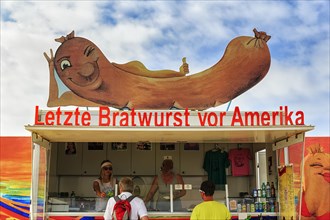 Customers at the food stall labelled Last Bratwurst in front of America