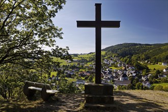 Cross of the Kreuzberg Chapel with a view of the Duedinghausen district of the town of Medebach