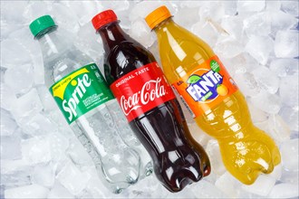 Coca Cola Coca-Cola Fanta Sprite lemonade drinks in plastic bottles on ice cube ice cubes