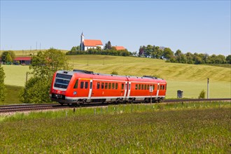 Bombardier Transportation RegioSwinger tilting technology regional train of Deutsche Bahn DB with church St. Alban in Allgaeu Bavaria in Aitrang