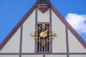 Clock on the gable of the town hall in Gemuenden am Main