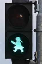 Pedestrian traffic light with green traffic light woman