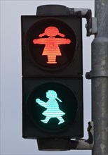 Pedestrian traffic light with red and green traffic light woman