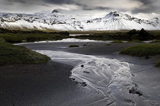 Mountain panorama with snow at low tide