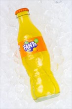 Fanta Orange lemonade soft drink drink in a bottle on ice cube ice cubes