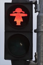 Pedestrian traffic light with red traffic light woman