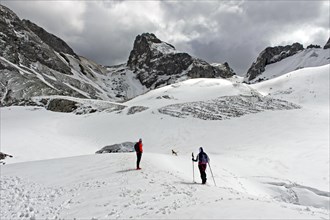 Winter hike at the snow-covered mountain lake Lac de la Case