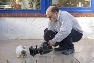 Animal photographer films Bolonka Zwetna puppy with 16mm camera